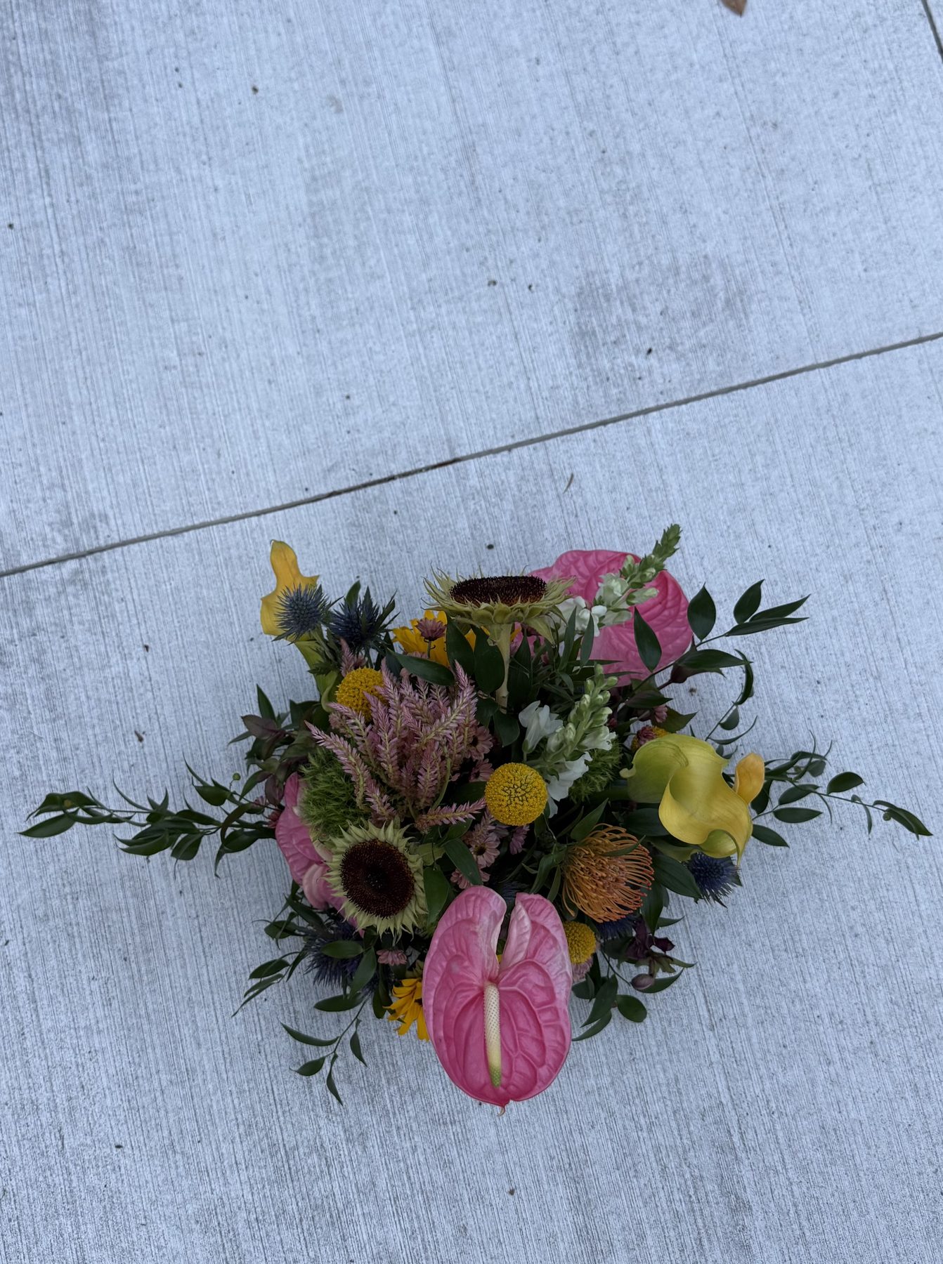 Sunflower, anthurium and thistle arrangement, overhead view