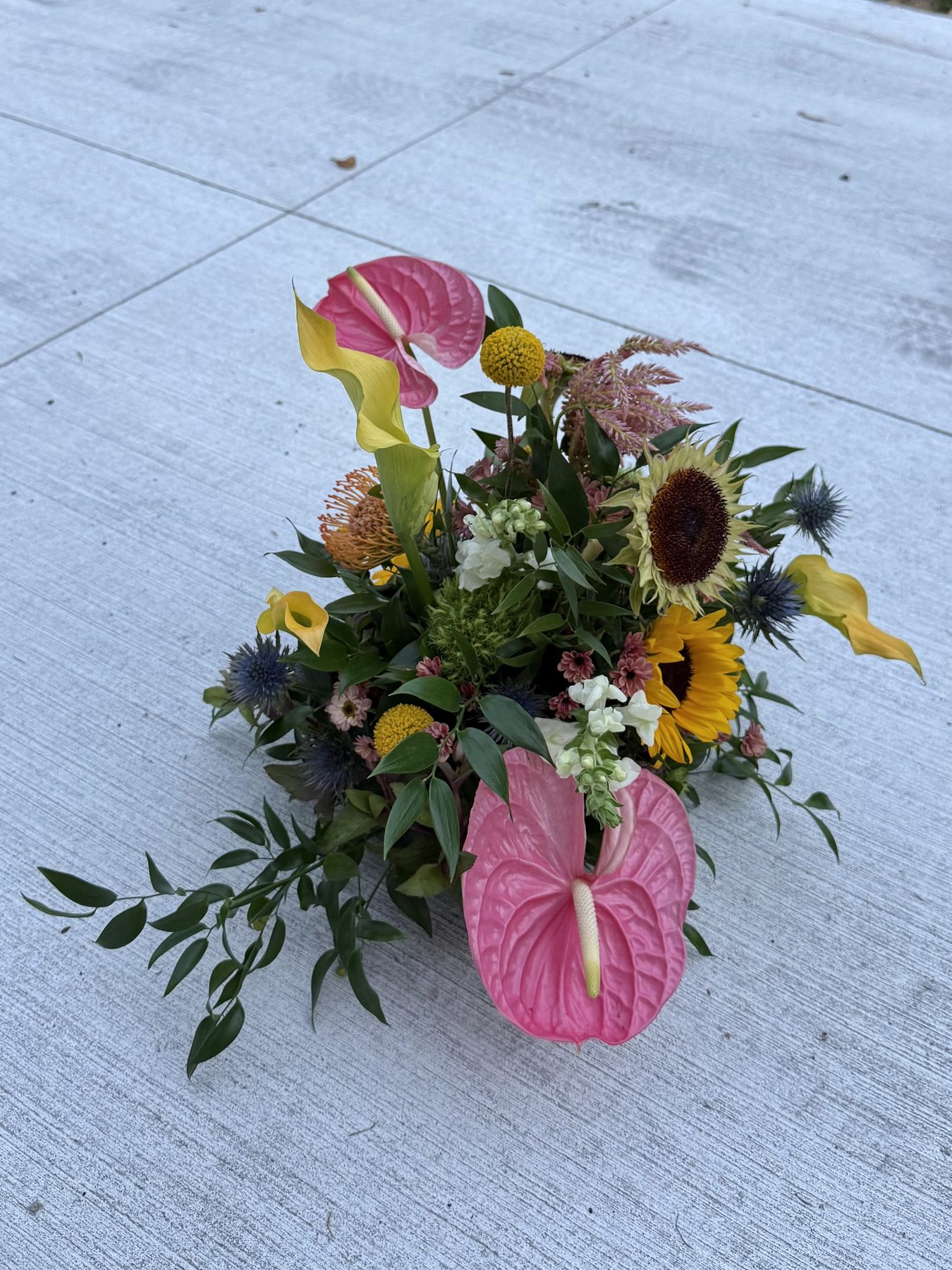 Sunflower, anthurium and calla lily arrangement, overhead view