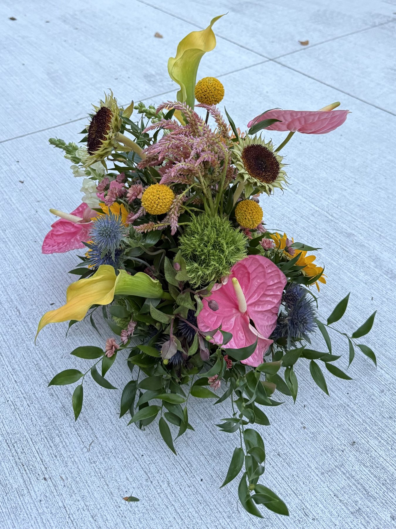 Calla lily, anthurium and sunflower arrangement with pincushion protea