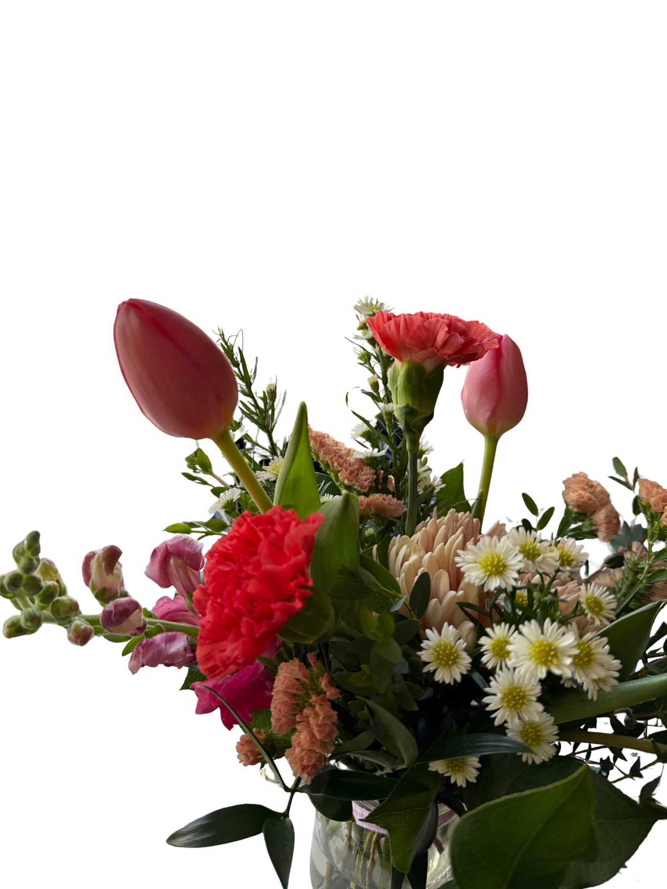 Close-up of coral tulips, carnations and daisies in a pink and cream palette